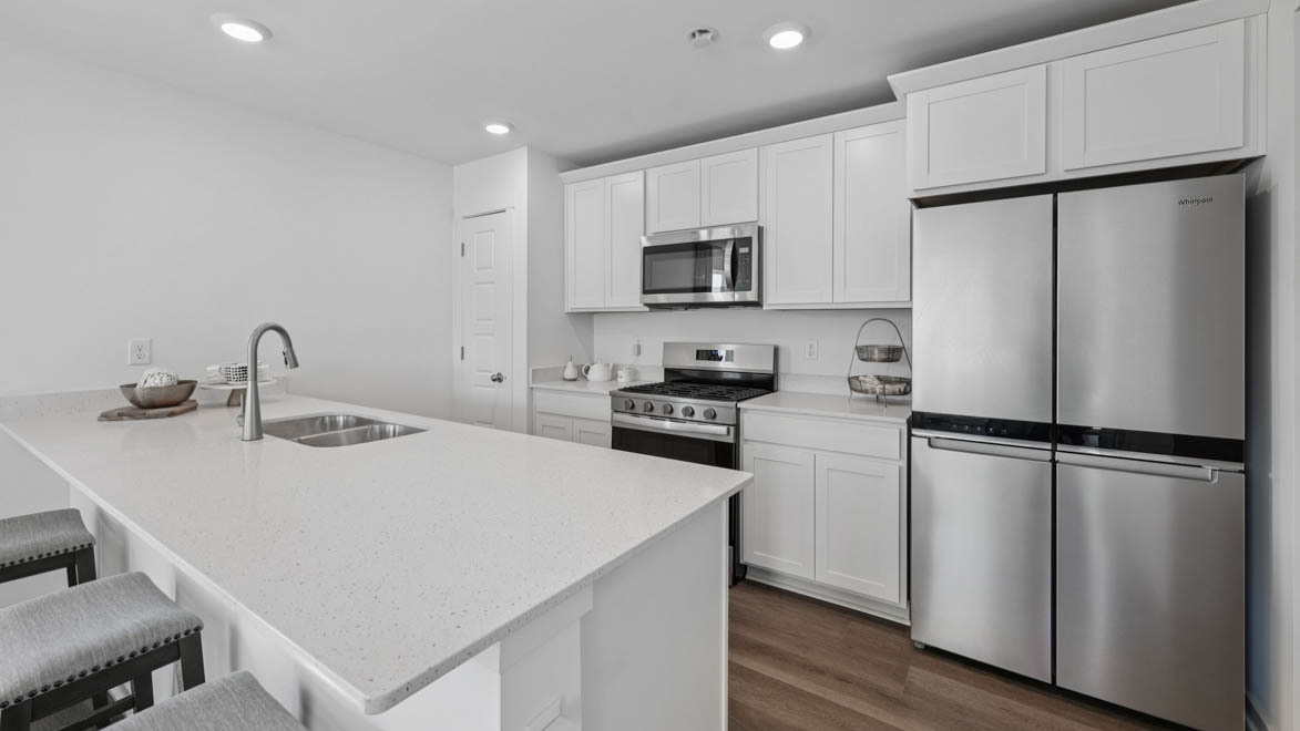 7105 Fair Oaks Road, Unit 38 Racine, WI 53403 - Photo 11 of 30 a kitchen with a refrigerator a stove top oven and a sink
