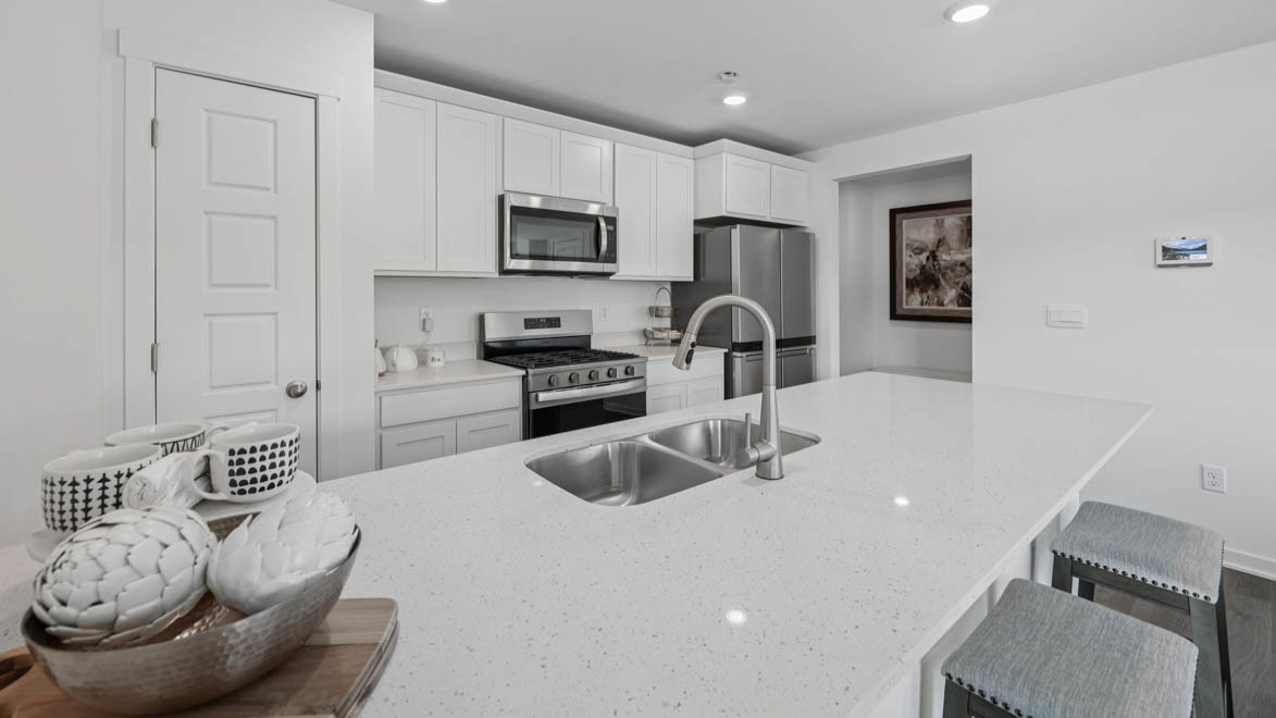 7105 Fair Oaks Road, Unit 38 Racine, WI 53403 - Photo 12 of 30 a kitchen with stainless steel appliances a sink a microwave a refrigerator and cabinets