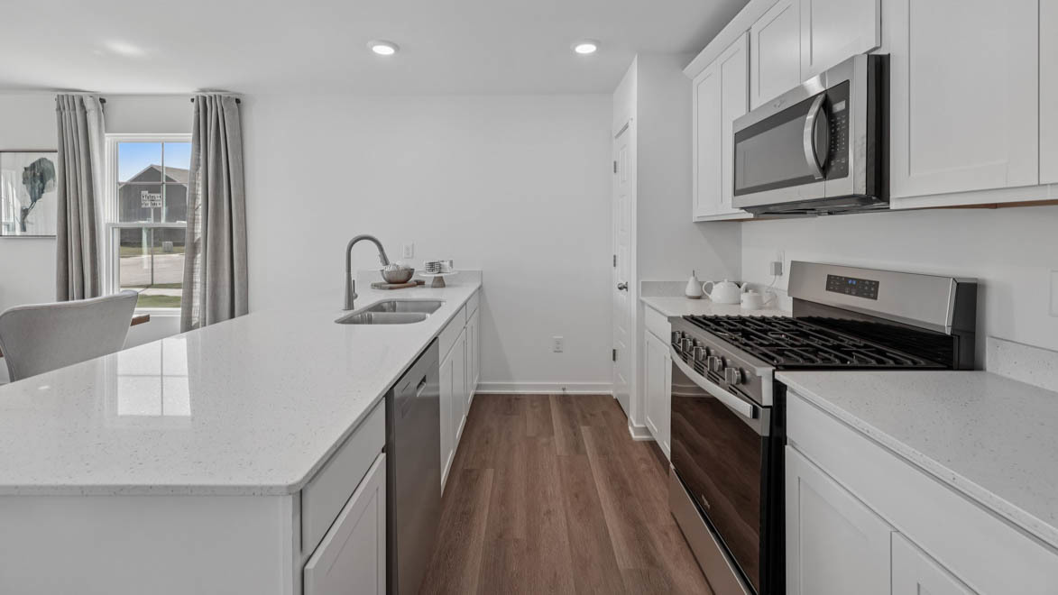 7105 Fair Oaks Road, Unit 38 Racine, WI 53403 - Photo 13 of 30 a kitchen that has a microwave a stove and a sink