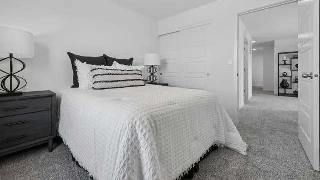 a spacious bedroom with a bed and cabinets