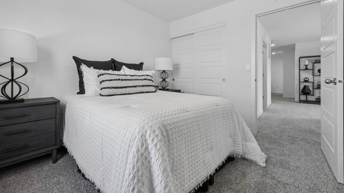 7105 Fair Oaks Road, Unit 38 Racine, WI 53403 - Photo 19 of 30 a spacious bedroom with a bed and cabinets