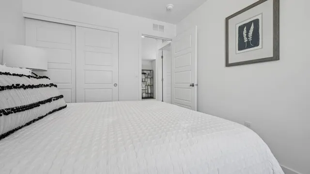 a bedroom with a bed and cabinets