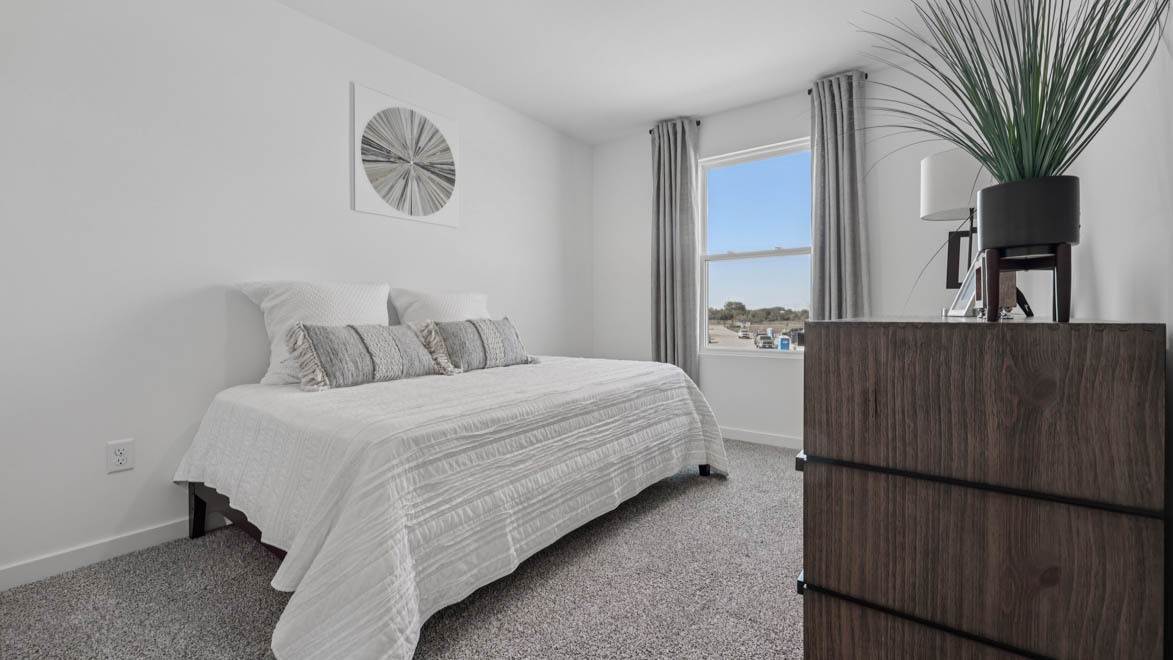 7105 Fair Oaks Road, Unit 38 Racine, WI 53403 - Photo 21 of 30 a bedroom with a bed and a painting on the wall