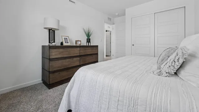 a bedroom with a bed and a lamp