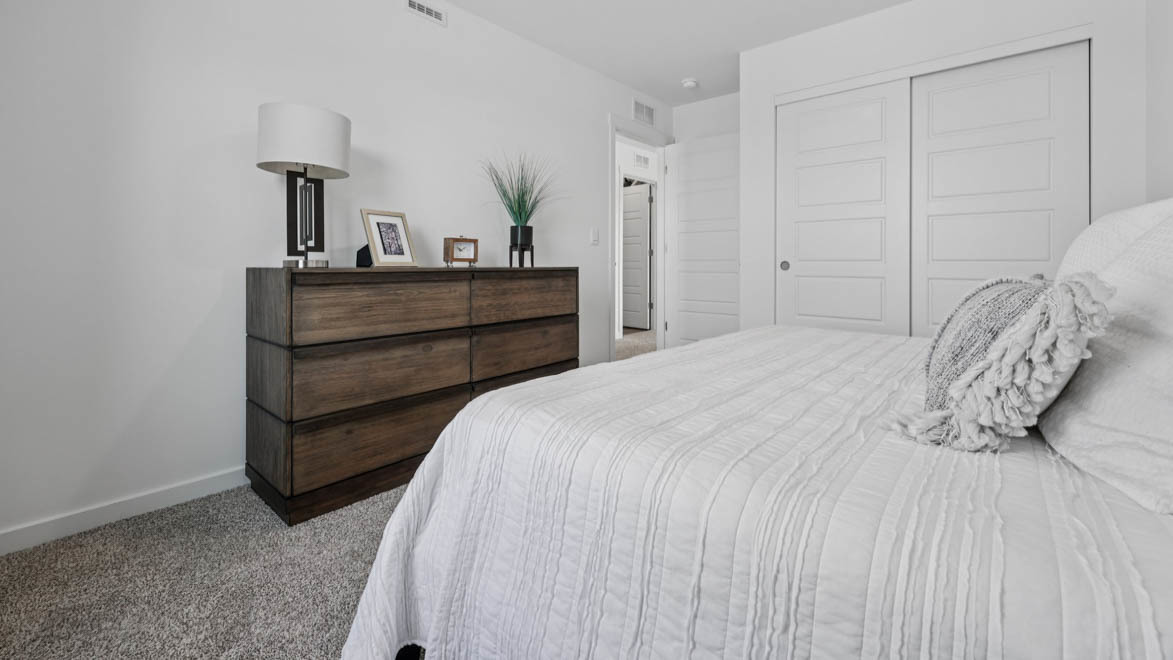 7105 Fair Oaks Road, Unit 38 Racine, WI 53403 - Photo 23 of 30 a bedroom with a bed and a lamp