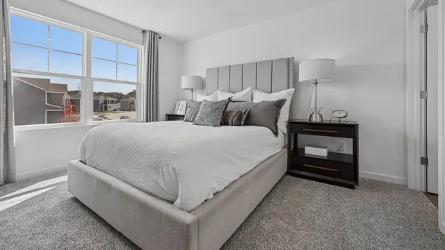 a bed room with a bed and a window