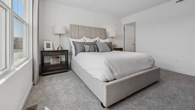 a living room with a bed and a night stand