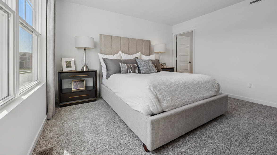 7105 Fair Oaks Road, Unit 38 Racine, WI 53403 - Photo 27 of 30 a living room with a bed and a night stand