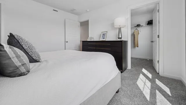 a bedroom with a bed and a table in it