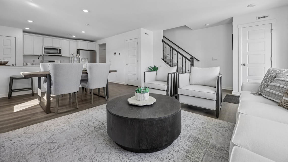 7105 Fair Oaks Road, Unit 38 Racine, WI 53403 - Photo 5 of 30 a living room with furniture and a dining table with kitchen view