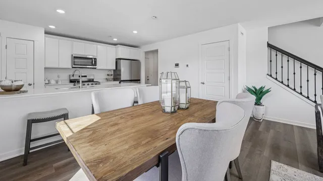 a kitchen with granite countertop kitchen island a dining table and chairs