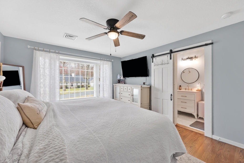 17 Glen Drive Wilbraham, MA 01095 - Photo 19 of 42 a bedroom with a bed a flat tv screen and a dresser