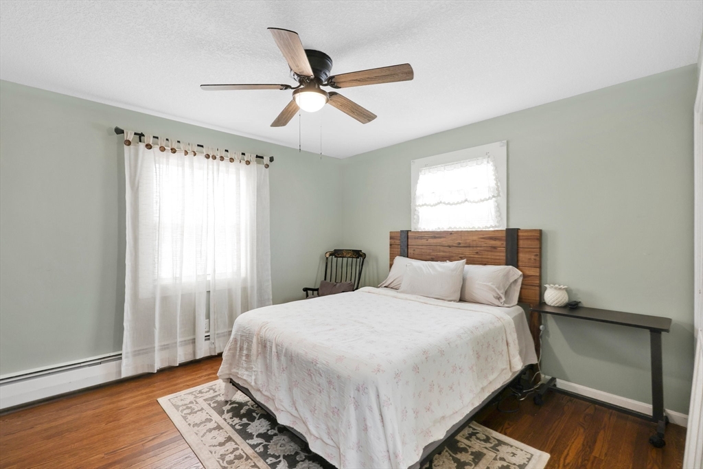 17 Glen Drive Wilbraham, MA 01095 - Photo 23 of 42 a bedroom with a large bed and a chandelier