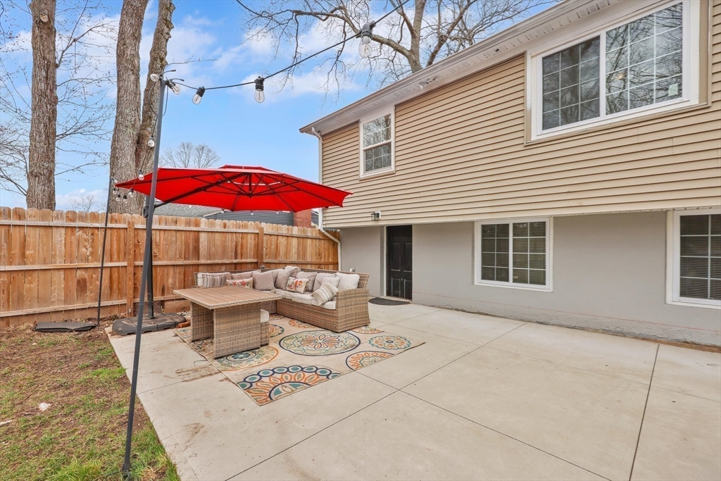 17 Glen Drive Wilbraham, MA 01095 - Photo 33 of 42 a patio with a table and chairs under an umbrella