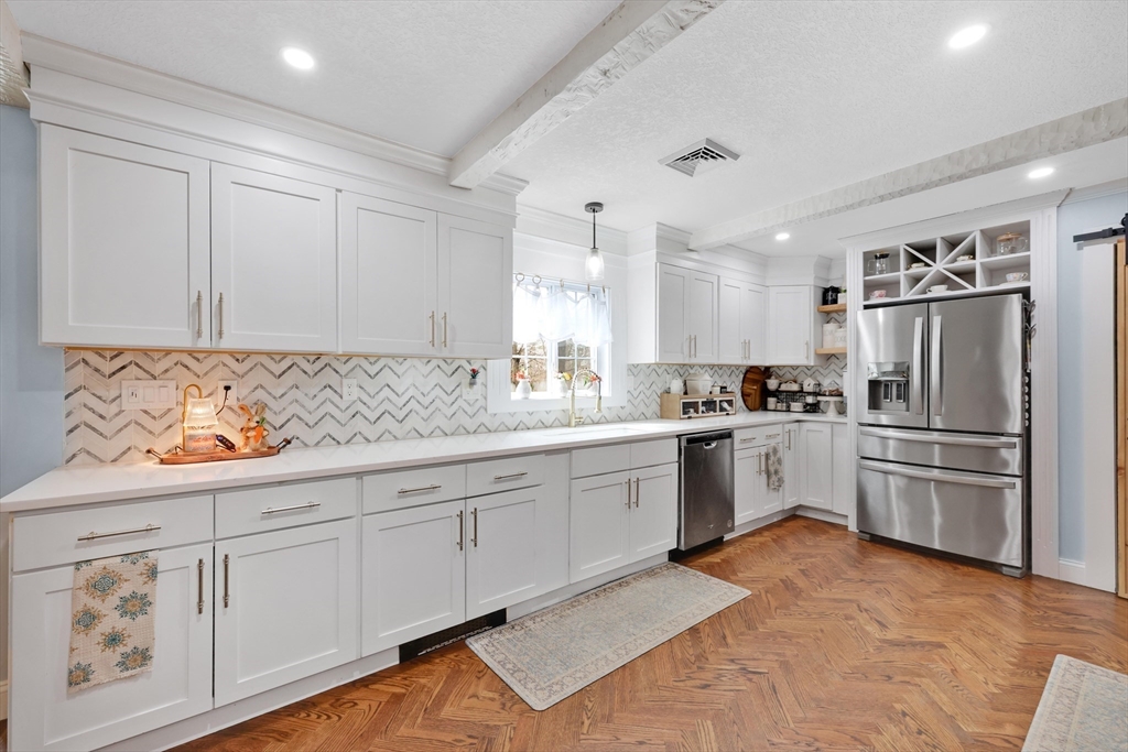 17 Glen Drive Wilbraham, MA 01095 - Photo 4 of 42 a kitchen with granite countertop white cabinets and stainless steel appliances