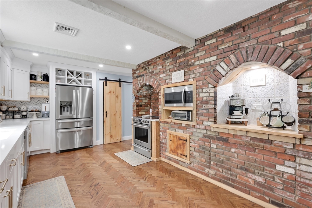 17 Glen Drive Wilbraham, MA 01095 - Photo 5 of 42 a kitchen with stainless steel appliances kitchen island granite countertop a refrigerator and microwave