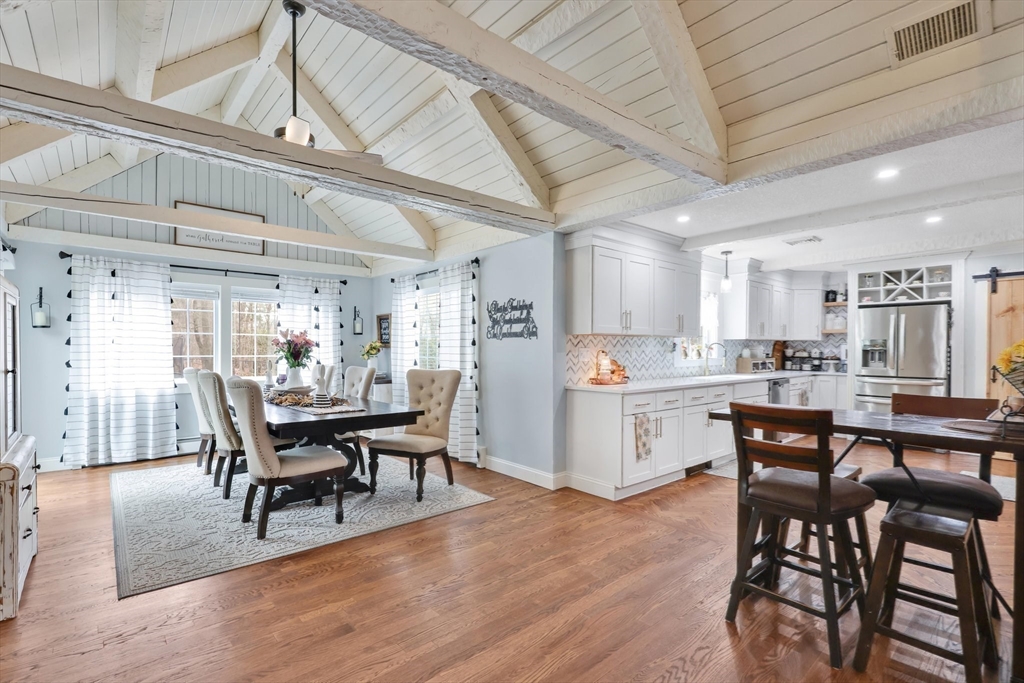 17 Glen Drive Wilbraham, MA 01095 - Photo 8 of 42 a kitchen with stainless steel appliances kitchen island granite countertop a dining table chairs and a oven