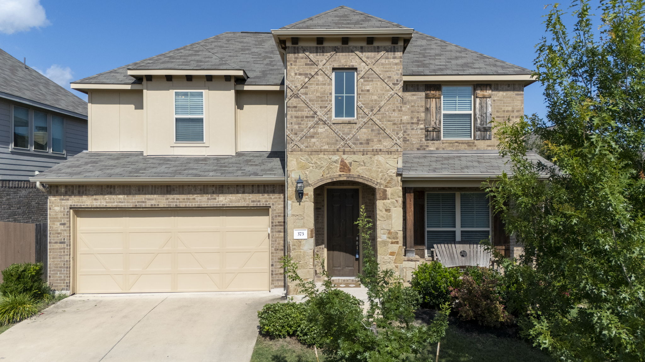 373 Rough Bark Street Buda, TX 78610 - Photo 37 of 39 A classic brick and stone facade welcomes you to this inviting residence.