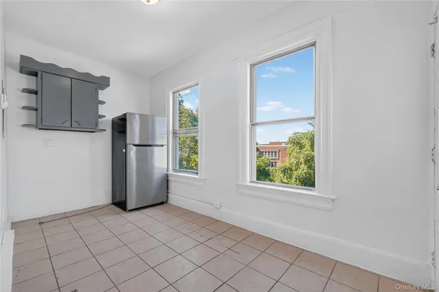 a view of a kitchen with a refrigerator cabinets and a window