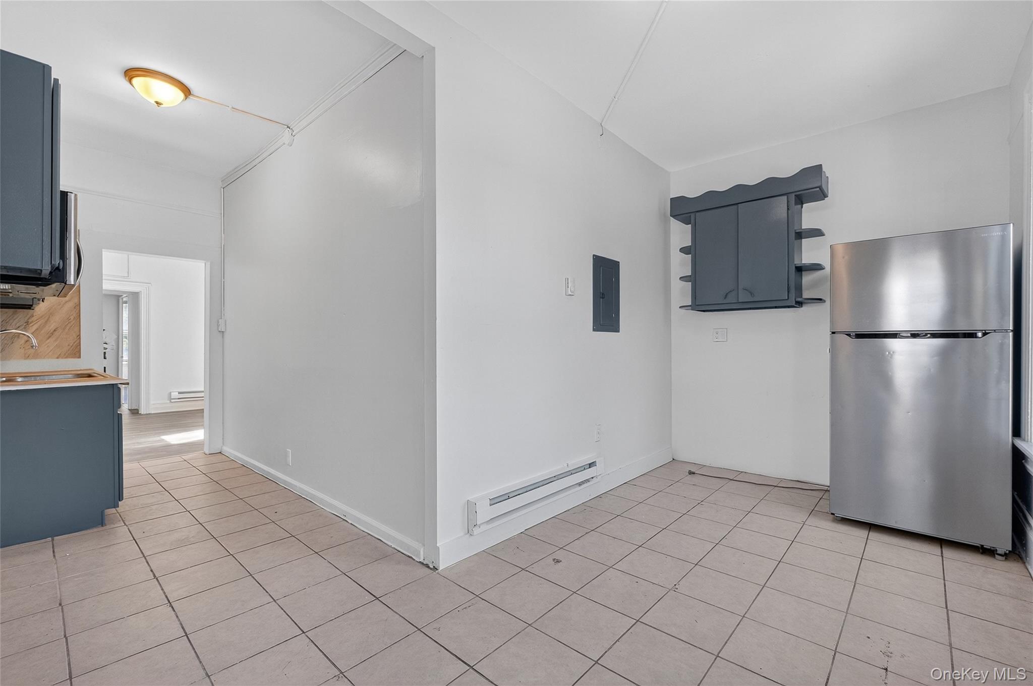 49 South Hamilton Street, Unit 2 Poughkeepsie, NY 12601 - Photo 19 of 27 a view of a kitchen with a refrigerator and a stove top oven