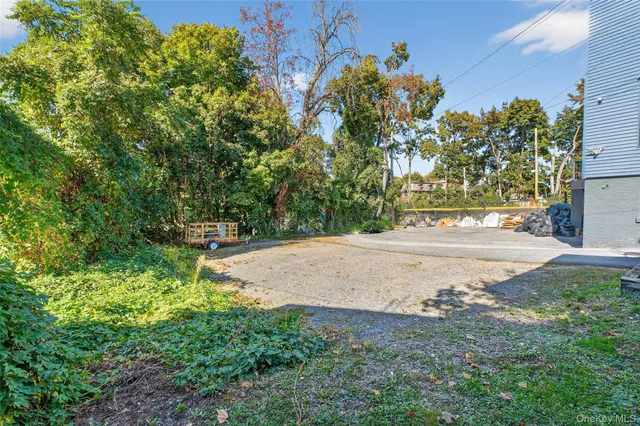 a view of a house with a yard and potted plants