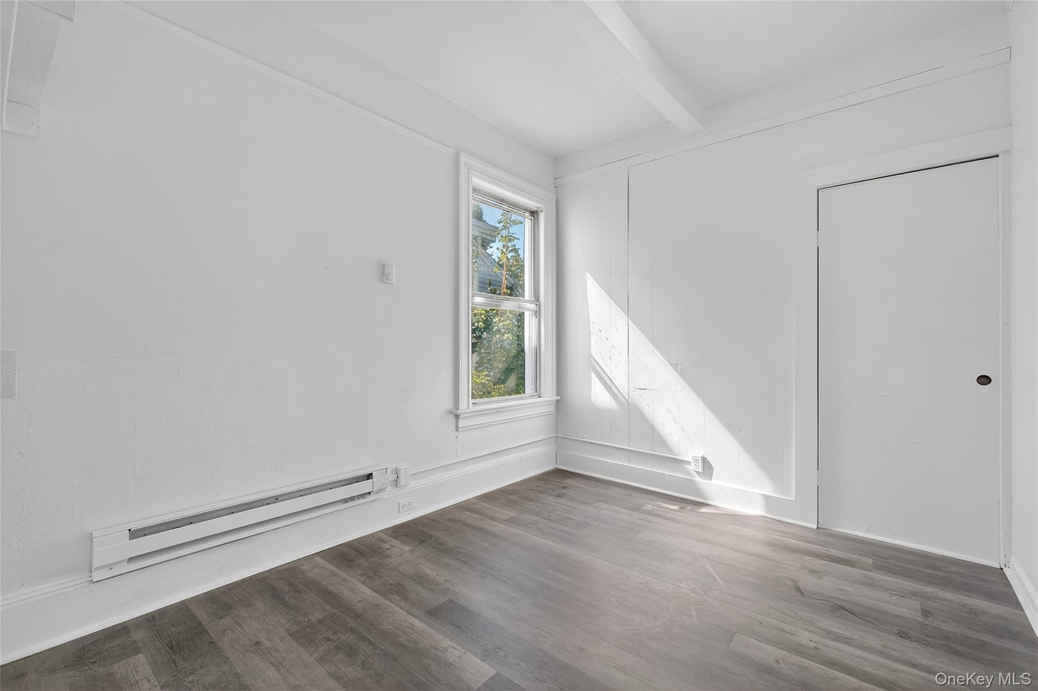 49 South Hamilton Street, Unit 2 Poughkeepsie, NY 12601 - Photo 8 of 27 an empty room with wooden floor and windows