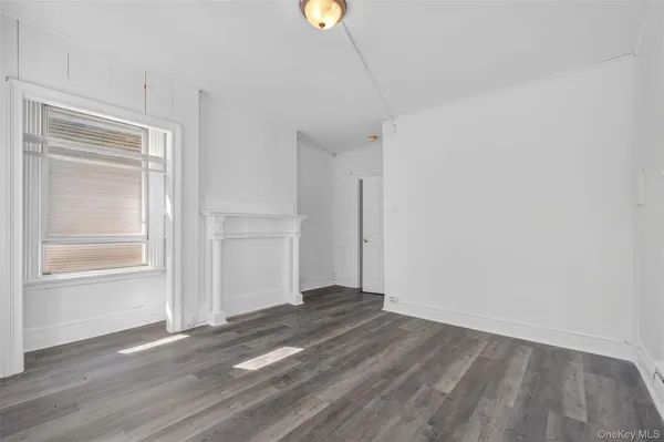 a view of a room with wooden floor and window