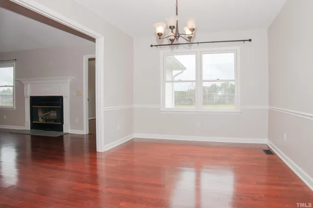 a view of a room with wooden floor and window