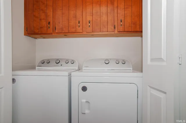 a kitchen with cabinets and steel stainless steel appliances