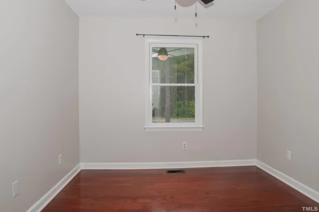 an empty room with wooden floor