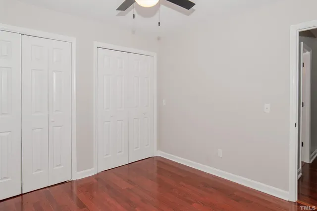a view of an empty room with wooden floor