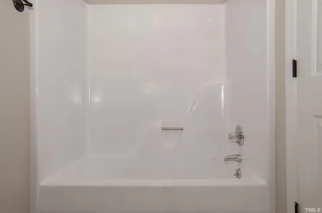 a bathroom with a granite countertop toilet and a sink
