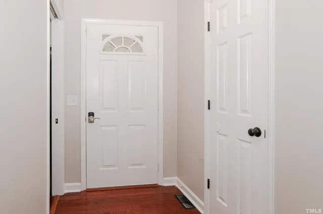 a view of a house with a door and wooden floor
