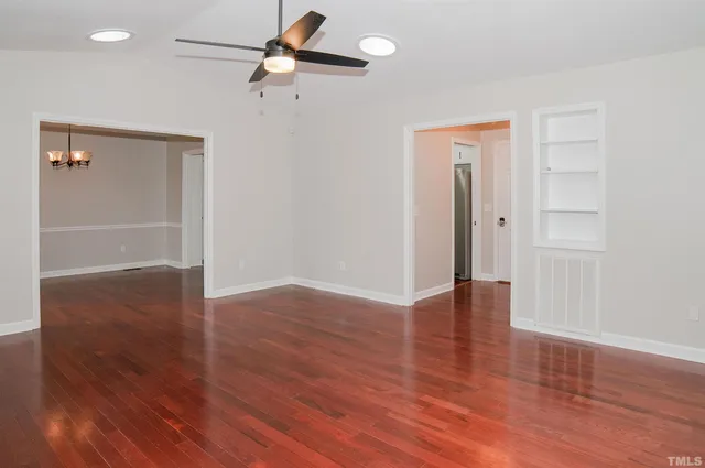 a view of a room with wooden floor