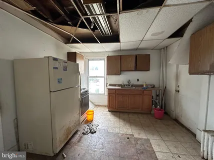 a kitchen with a refrigerator and a stove