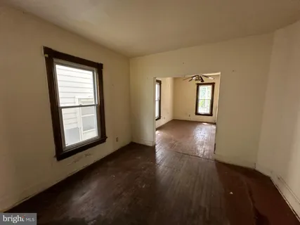 a view of a room with wooden floor and window