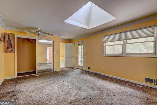 a view of an empty room with a window