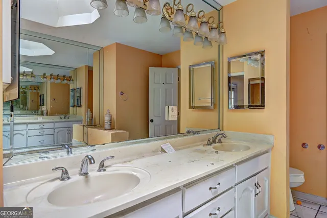 a bathroom with a tub sink and mirror
