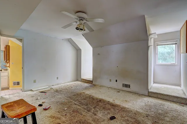 a view of a livingroom with a hardwood floor and a ceiling fan