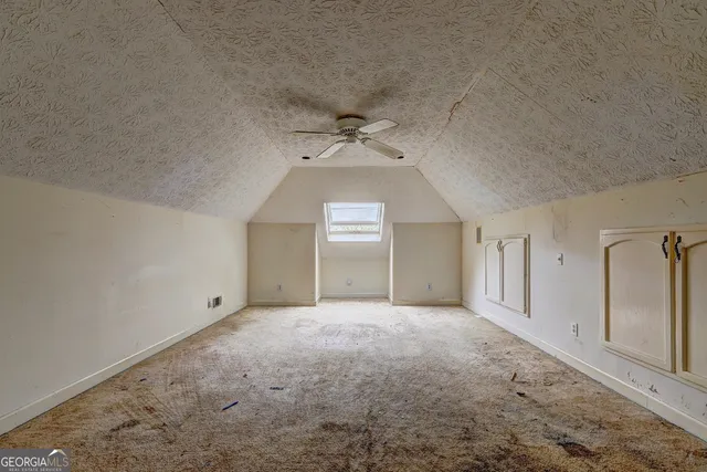 a view of a livingroom with a ceiling fan and window