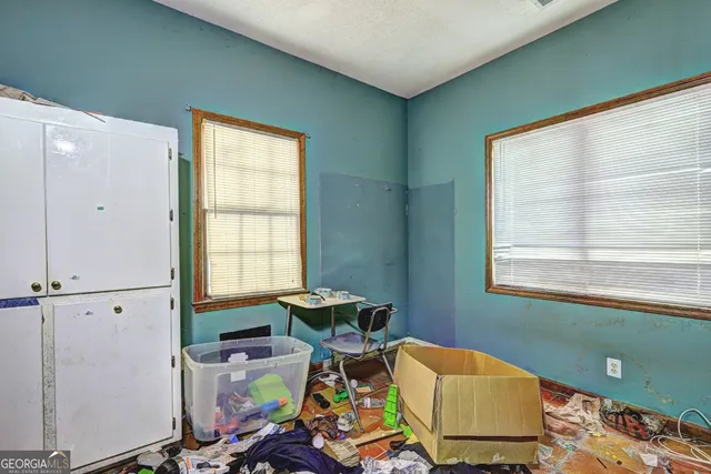 a room with furniture and floor to ceiling windows