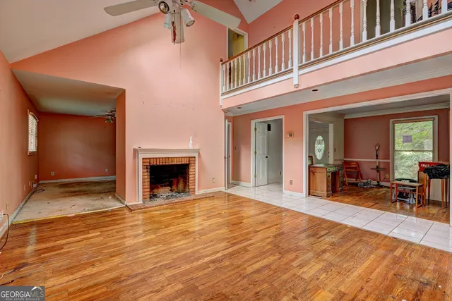 a view of a livingroom with wooden floor and a fireplace
