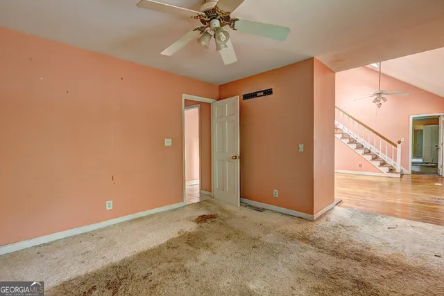 a view of a livingroom with a chandelier fan and entryway