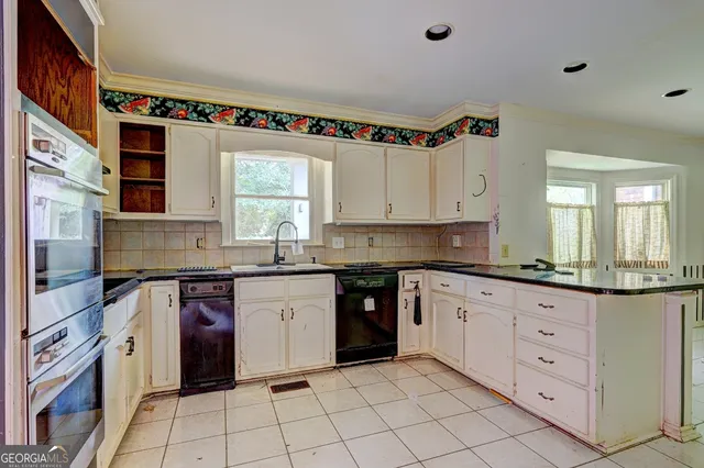 a kitchen with granite countertop white cabinets and white appliances