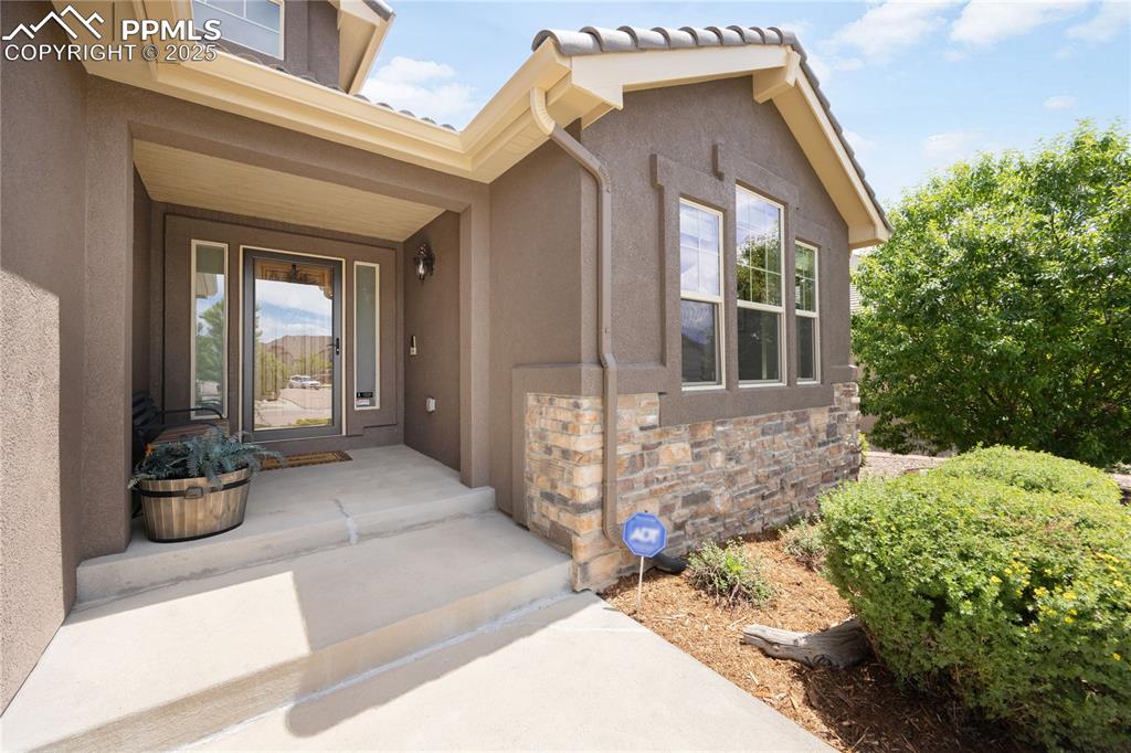 1131 Old North Gate Road Colorado Springs, CO 80921 - Photo 2 of 39 Entrance to home with stucco siding and stone