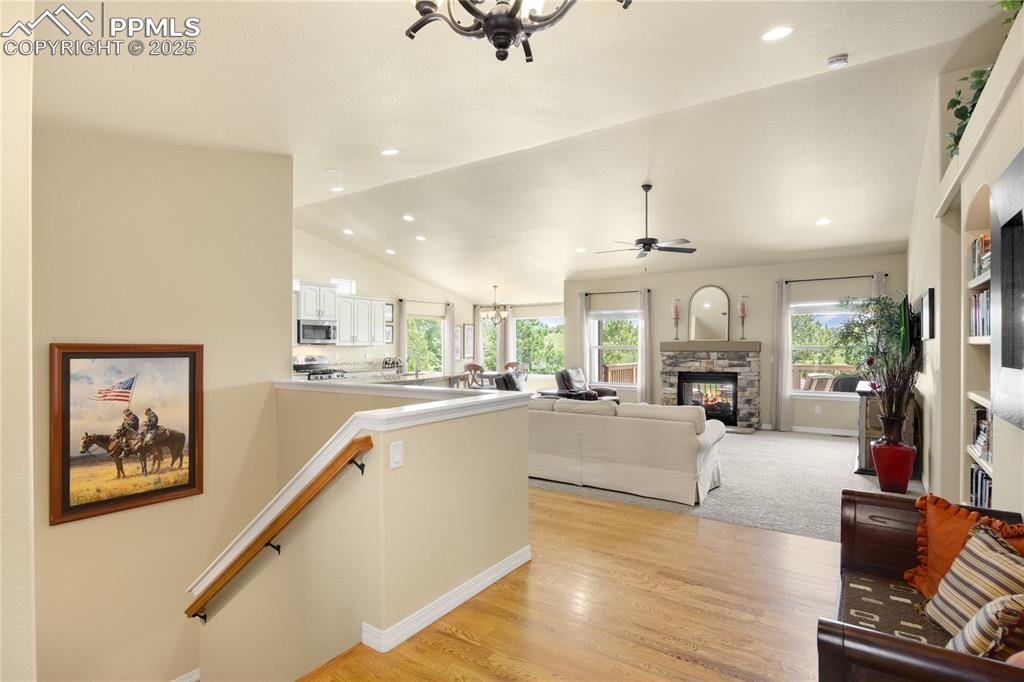 1131 Old North Gate Road Colorado Springs, CO 80921 - Photo 3 of 39 Entry from front door into the Living area featuring healthy amount of natural light, vaulted ceiling, a fireplace and recessed lighting