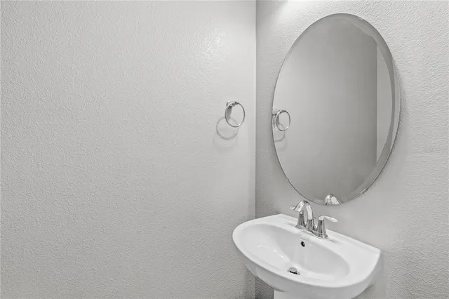 a bathroom with a sink and mirror