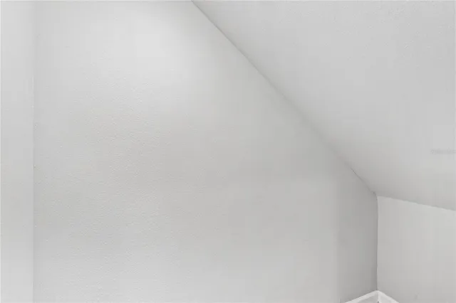 a view of a room with wooden floor and white walls