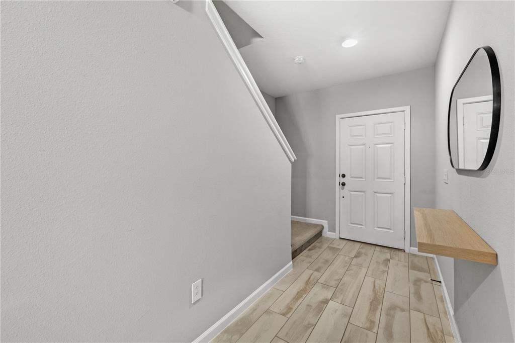 260 Smugglers Way Apopka, FL 32712 - Photo 15 of 34 a view of a room with wooden floor and white walls