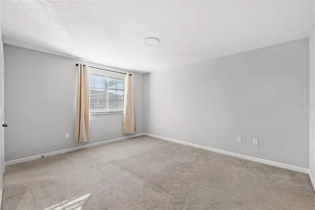 a view of an empty room with a kitchen